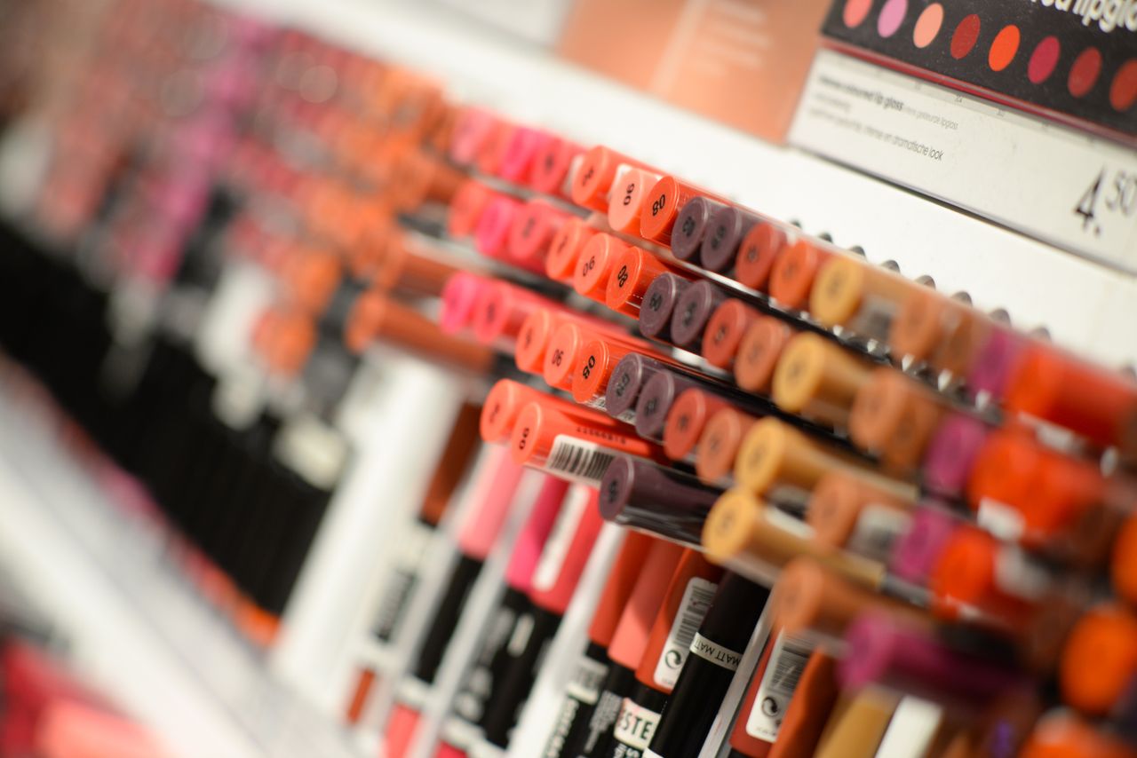 services-03 Close-up of diverse lipsticks in a store showcasing various shades and brands for beauty enthusiasts.