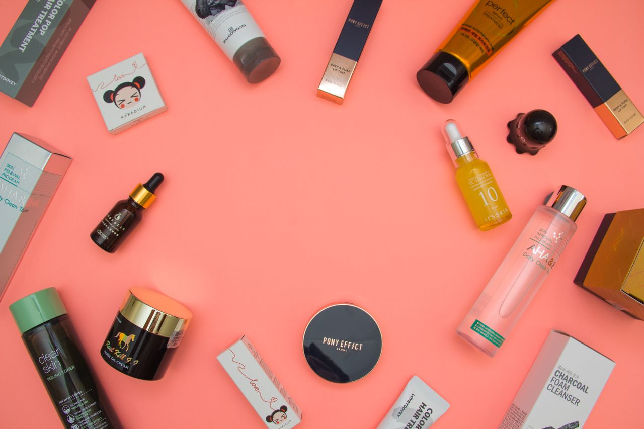 hero Top view of various cosmetic products for skincare and beauty in different bottles placed on pink surface
